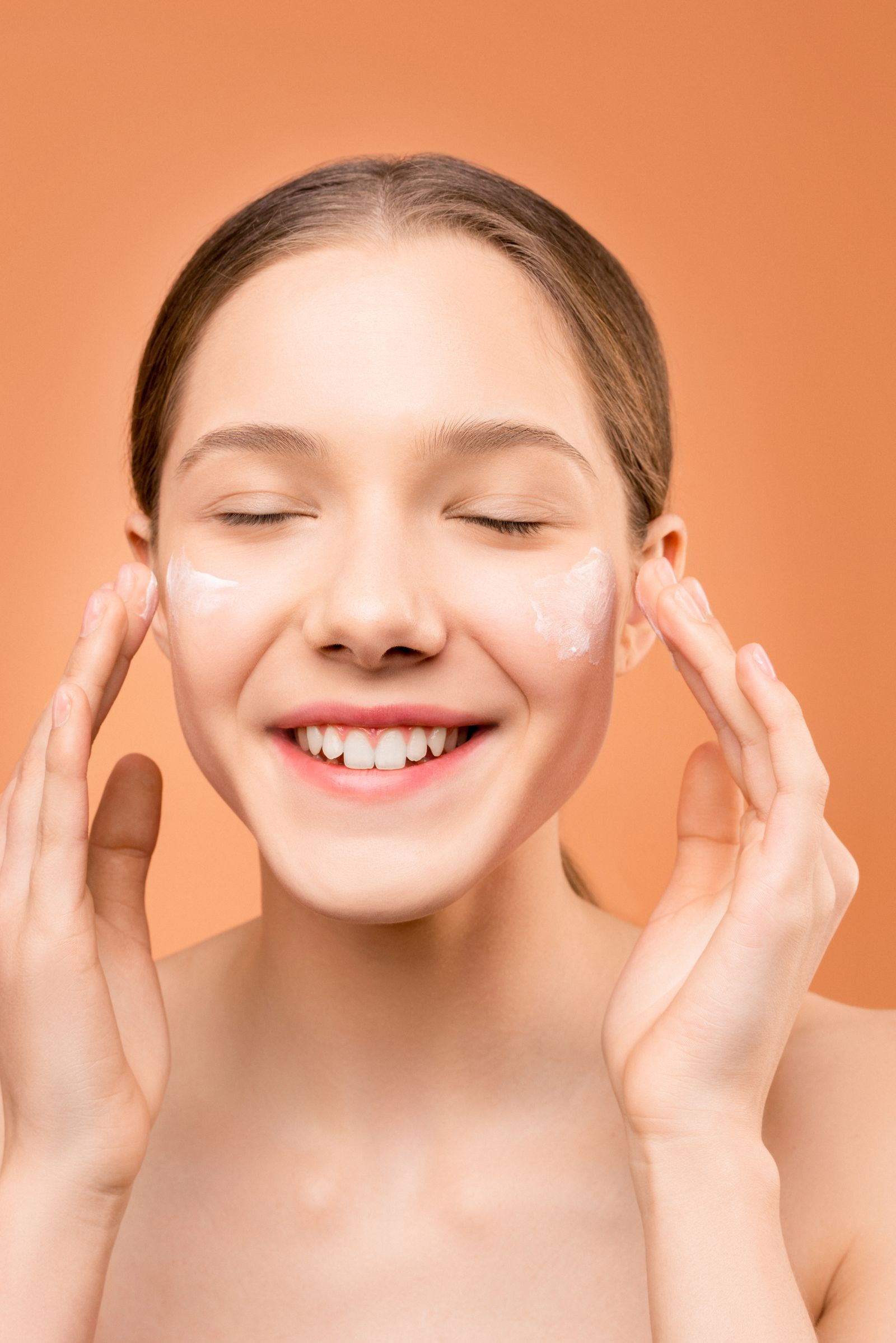 Person applying facial moisturiser with a gentle touch