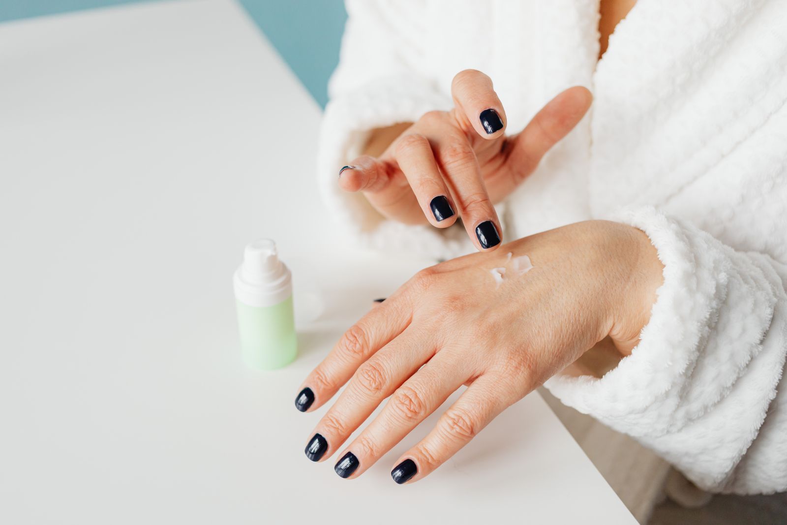 Person applying moisturising cream to their hands